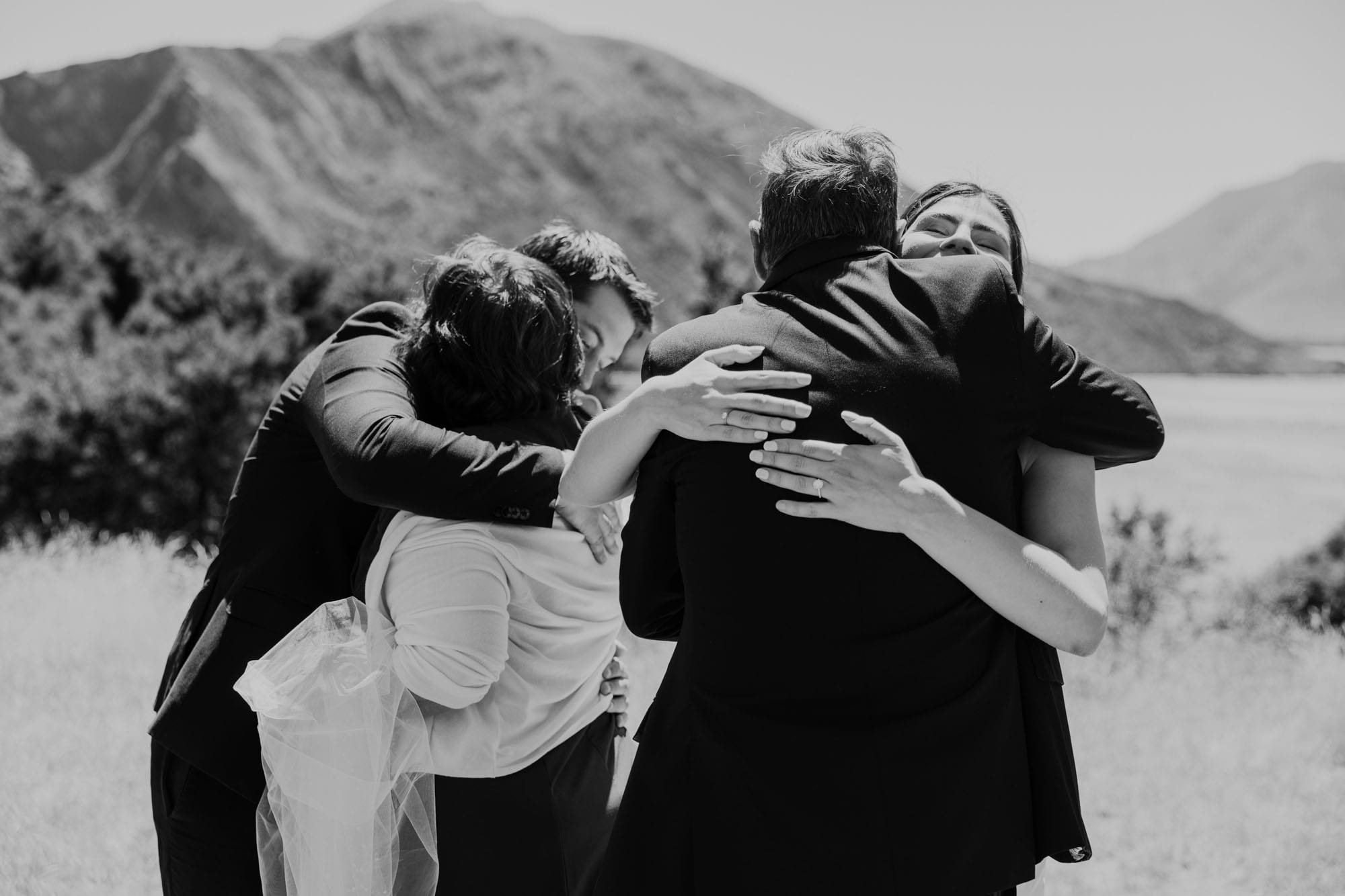 The couple held in an embrace by their guests